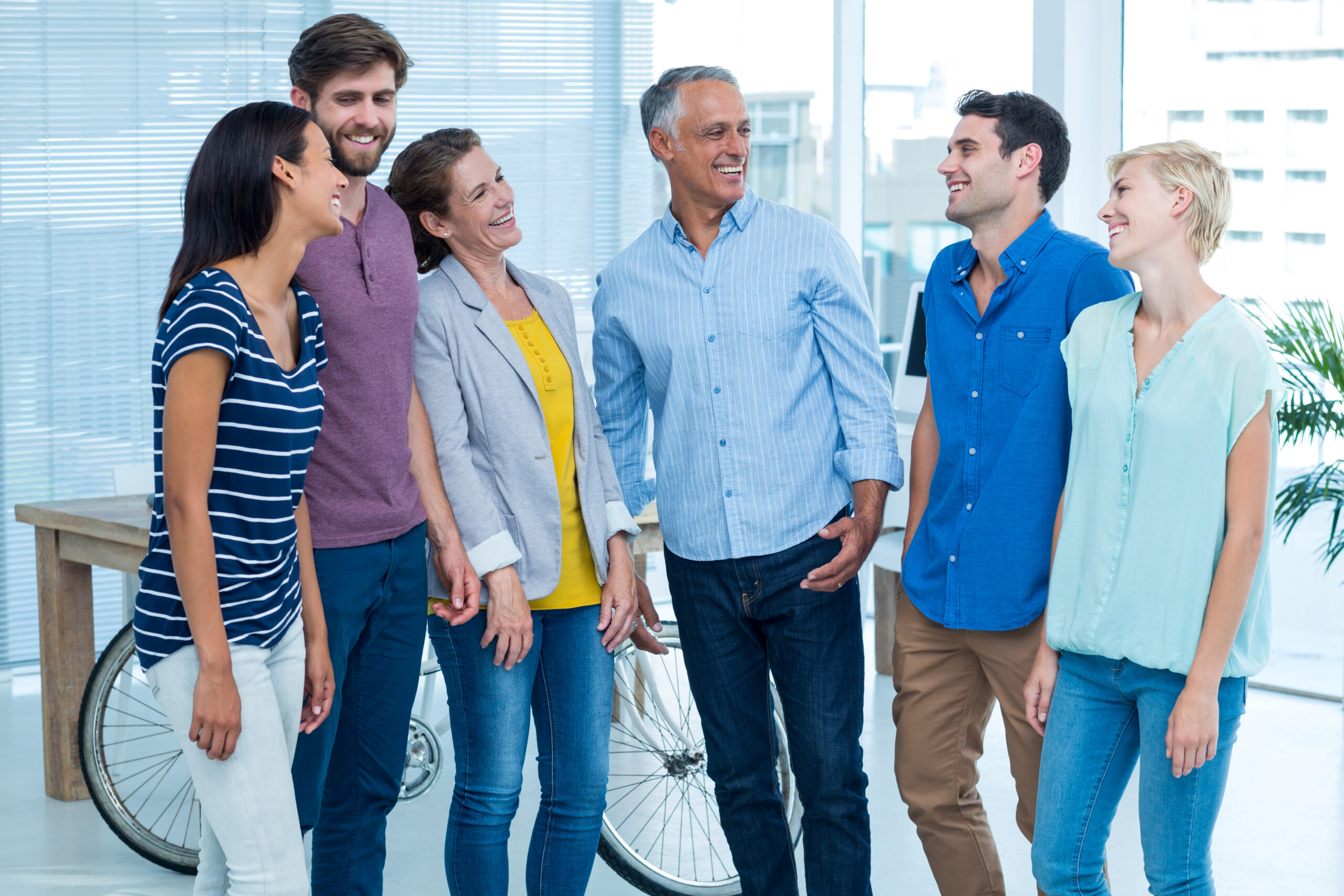 Smiling business team talking together in the office